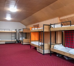 Кровать в общем номере с красивым видом из окна в Almaty BackPackers