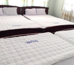 Кровать в общем номере в Vuta Hotel