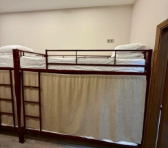 Кровать в мужском шестиместном номере в Берег